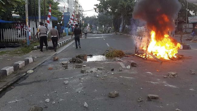 Ilustrasi kerusuhan di tanah Papua. (STR / AFP/CNN)