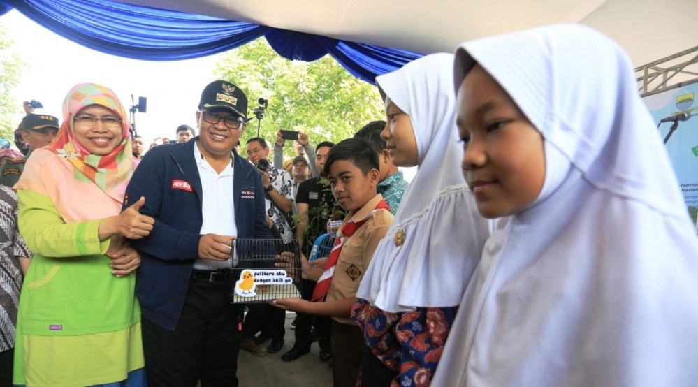 Wali Kota Bandung, Oded M. Danial, dan Ketua TP PKK Kota Bandung, Siti Muntamah, saat menyerahkan anak ayam kepada siswa SD dan SMP, Kamis (21/11/2019). Foto: Humas Bandung