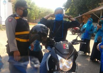 Semua pengguna jalan yang melintas ke Desa sadawarna diberi masker oleh jajaran kepolisian (Foto: Yudi/dara.co.id)