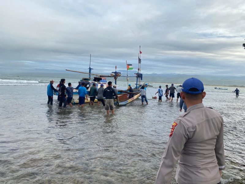 Anggota Satpolairud Polres Garut bersama nelayan dan masyarakat mengevakuasi 3 orang nelayan yang terdampar di hamparan karang Pantai Karang Kukus, Kecamatan Pameungpeuk, Kabupaten Garut, Selasa (5/3/2024)(Foto: Ist)